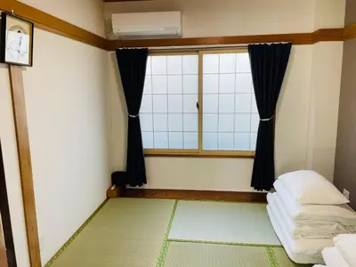 a small room with a window and a bed at Sakae House in Tokyo