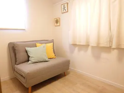a chair with two pillows on it in a room at \u697d\u9038 \u4e2d\u4e95 104t in Tokyo
