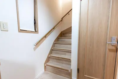 a staircase in a house with a mirror and a door at \u697d\u9038 \u4e2d\u4e95 104t in Tokyo