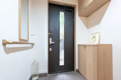 a black door in a room with a wooden cabinet at \u697d\u9038 \u4e2d\u4e95 104t in Tokyo