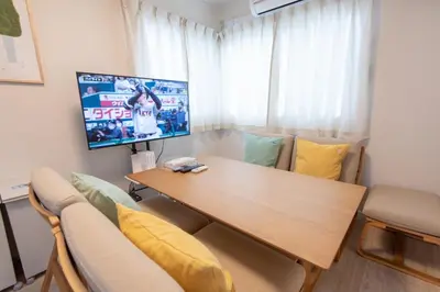 a living room with a table and a tv at \u697d\u9038 \u4e2d\u4e95 104t in Tokyo