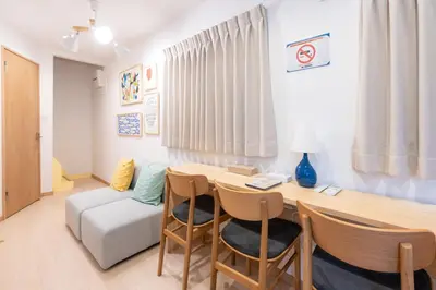 a living room with a table and chairs and a couch at \u697d\u9038\u30b0\u30eb\u30fc\u30d7Skytree 105T in Tokyo