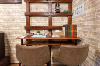 an office with a wooden desk and two chairs at \u5b50\u732b\u306e\u5bb6 103t in Tokyo