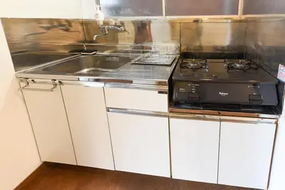 a kitchen with a stove and a sink at \u5b50\u732b\u306e\u5bb6 103t in Tokyo