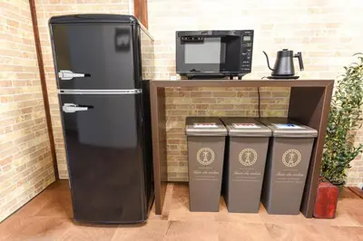 a refrigerator and two trash cans and a microwave at \u5b50\u732b\u306e\u5bb6 103t in Tokyo
