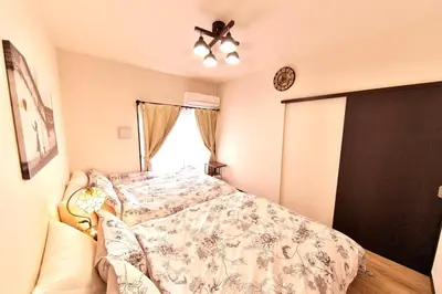 a bedroom with a bed and a ceiling fan at Y's INN 池袋西 029T in Tokyo
