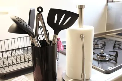 a container of utensils on a counter next to a stove at Y's INN 池袋西 029T in Tokyo
