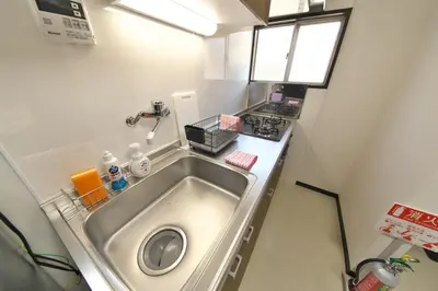 a small kitchen with a sink and a stove at Y's INN 池袋西 029T in Tokyo