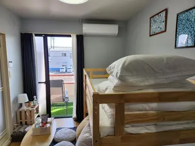 a bedroom with a bed and a window at Cozy Zoom-Easy access to UENO ASAKUSA AKIHABARA R3 in Tokyo