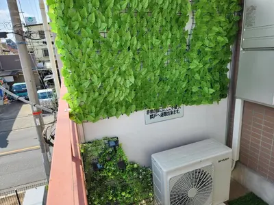 a green ivy is growing on the side of a building at Cozy Zoom-Easy access to UENO ASAKUSA AKIHABARA R3 in Tokyo