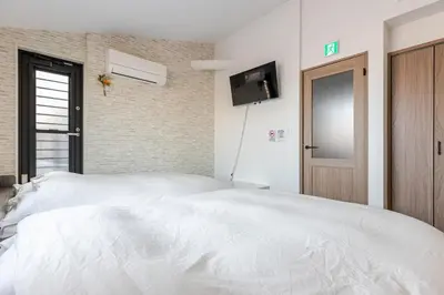 a bedroom with a white bed with a tv on the wall at ksf\u4e0a\u6c60\u888b3\u4e01\u76ee301 in Tokyo