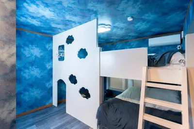 a bedroom with a blue ceiling with clouds at Fantasy Lodge in Tokyo