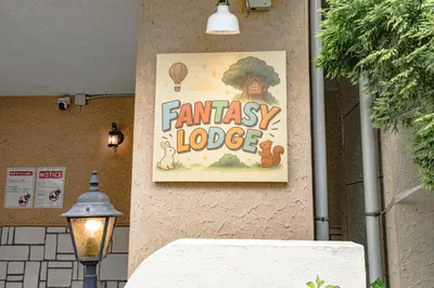 a sign on a wall that reads embassy lodge at Fantasy Lodge in Tokyo