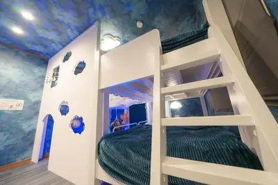 a bunk bed in a room with a blue ceiling at Fantasy Lodge in Tokyo