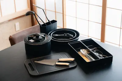 a black table with a tray with utensils on it at ERA 1927 Koenji in Tokyo