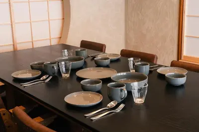 a table with empty plates and silverware on it at ERA 1927 Koenji in Tokyo