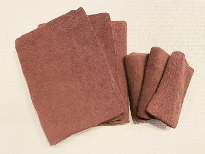 a pair of brown towels sitting on a table at ERA 1927 Koenji in Tokyo