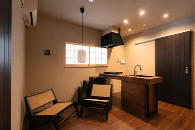 a kitchen with a sink and two chairs and a counter at ERA 1927 Koenji in Tokyo