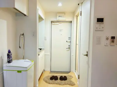 a bathroom with a shower and a pair of shoes at Shin-Koenji loft apartment close to Tokyo Metro14mins to Shinjuku in Tokyo