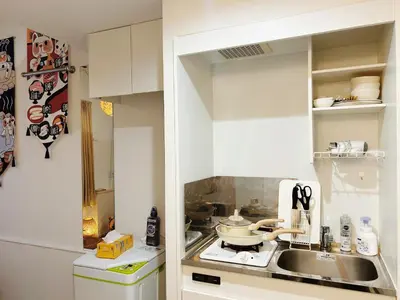 a kitchen with a sink and a refrigerator at Shin-Koenji loft apartment close to Tokyo Metro14mins to Shinjuku in Tokyo