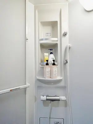a refrigerator with a door open with products on it at Shin-Koenji loft apartment close to Tokyo Metro14mins to Shinjuku in Tokyo