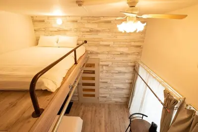 a small room with a bed and a balcony at \u30b9\u30ef\u30f3\u30d1\u30fc\u30af\u6c60\u888b in Tokyo