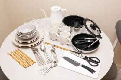 a white table with plates and utensils on it at \u30b9\u30ef\u30f3\u30d1\u30fc\u30af\u6c60\u888b in Tokyo