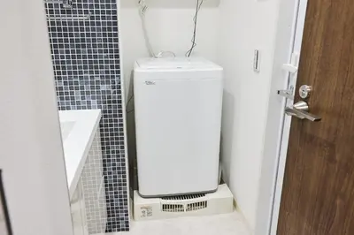 a white toilet in a bathroom next to a door at Miyabi \u795e\u697d\u5742 in Tokyo