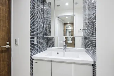 a bathroom with a white sink and a mirror at Miyabi \u795e\u697d\u5742 in Tokyo