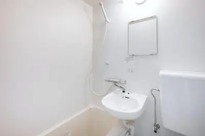 a white bathroom with a sink and a mirror at Hit\u9326\u7cf8\u753a in Tokyo