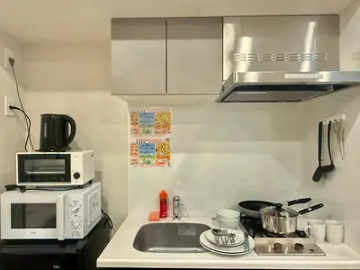 a small kitchen with a sink and a microwave at Uhome Fabric Hotel in Tokyo
