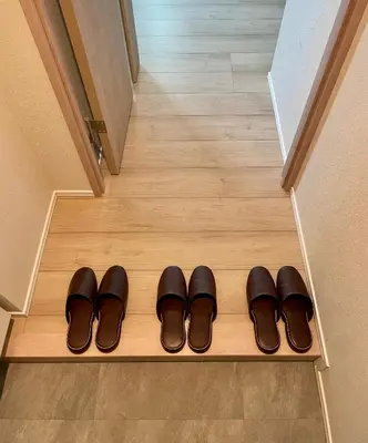 a pair of shoes sitting on a wooden floor at Uhome Fabric Hotel in Tokyo