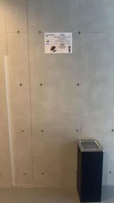 a wall with a sign on it next to a box at Uhome Fabric Hotel in Tokyo