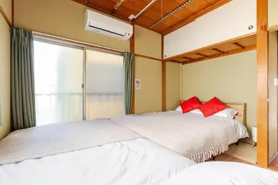 a bedroom with two beds and a window at won\u58a8\u75305\u4e01\u76ee in Tokyo
