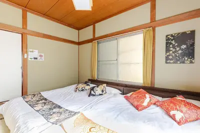 two dogs laying on a bed in a bedroom at won\u58a8\u75305\u4e01\u76ee in Tokyo