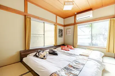 two beds in a room with two windows at won\u58a8\u75305\u4e01\u76ee in Tokyo