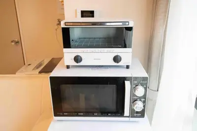 a toaster oven and a microwave on a counter at FIKA Asakusa in Tokyo
