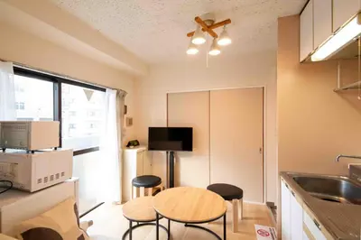a kitchen with a table and chairs in a kitchen at FIKA Asakusa in Tokyo