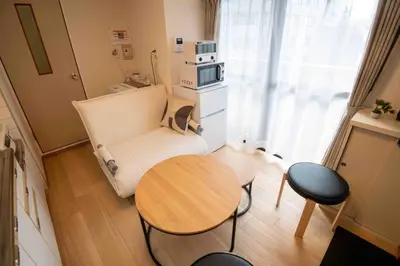 a small room with a table and a couch at FIKA Asakusa in Tokyo