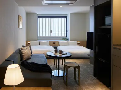 a hotel room with a bed and a couch and a table at Minn Nihonbashi Suitengumae in Tokyo