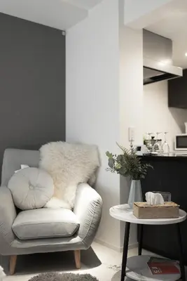 a living room with a chair and a table at Roppongi Designer Apartment Newly built 5 minutes walk to the station in Tokyo