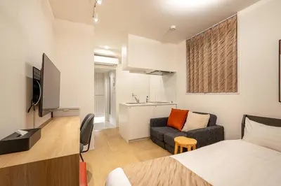 a small room with a bed and a couch at TOKYO SHIBA Retreat 3427 in Tokyo