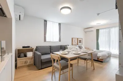 a living room with a table and a couch at TOKYO SHIBA Retreat 3427 in Tokyo