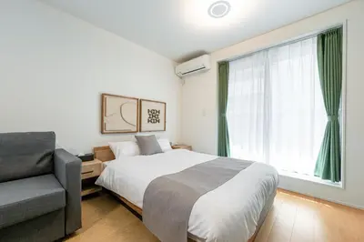 a bedroom with a bed and a chair and a window at TOKYO SHIBA Retreat 3427 in Tokyo