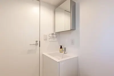 a white bathroom with a sink and a cabinet at TOKYO SHIBA Retreat 3427 in Tokyo