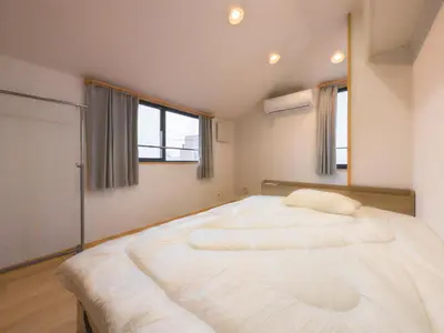 a large white bed in a room with windows at Miyabi Inn-Higashi Koiwa in Tokyo