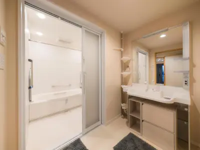 a bathroom with a shower and a sink and a mirror at Miyabi Inn-Higashi Koiwa in Tokyo
