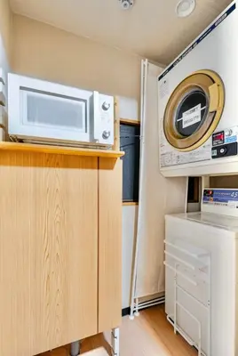 a microwave on top of a cabinet in a kitchen at \u4e0a\u91ce\u65e5\u5f0f\u6c11\u5bbf in Tokyo