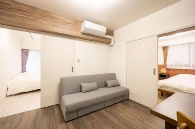 a living room with a couch and a bedroom at Vacation Inn Omorikaigan in Tokyo