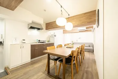 a kitchen and dining room with a wooden table and chairs at Vacation Inn Omorikaigan in Tokyo